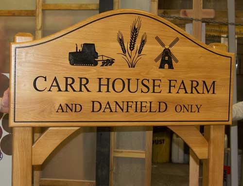 Large shaped oak sign on posts