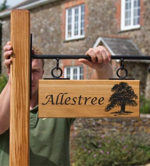 Oak sign with wrought iron bracket