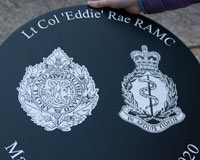 Detailed laser etched crests painted onto slate.