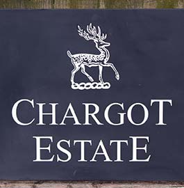 Large slate sign with Chargot Estate logo.