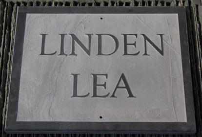 Slate house sign with raised letters and a border