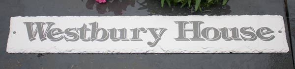 Rustic slate sign created in reverse.