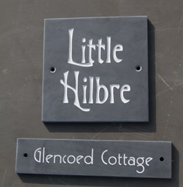 Slate house signs with unusual fonts.