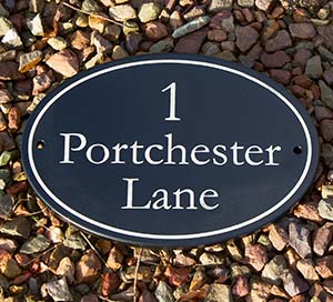 Black painted oval slate with laser etched lettering.