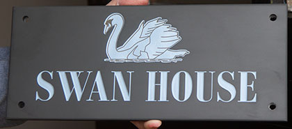 Detailed swan image on slate sign.