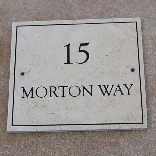 This sign has a painted line border Limestone Address Sign