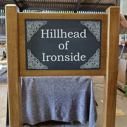 Engraved slate inset into oak frame. Superior Entrance Sign