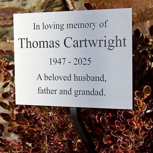 Plaque fixed to a wrought iron tree stake with metal plate.. Laser Engraved Stainless Steel Plaque