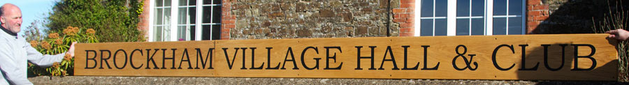 long wooden sign treated with a commercial varnish.