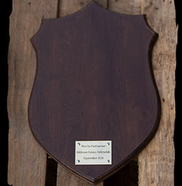Antique oak sheild with brass plaque.