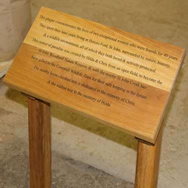 Solid wooden stand with wooden sign attached