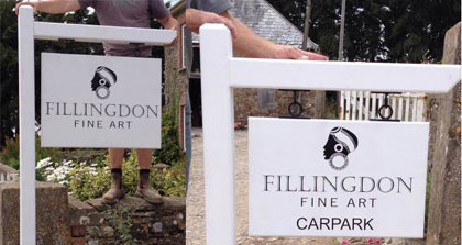 White wooden signs with wrought iron fixings
